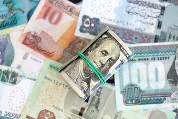 Egyptian pound currency money bills and bunch of us dollars. The concept of currency exchange