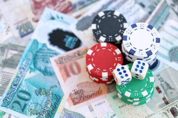 Egyptian pound currency money bills and casino chips with dice. The concept of gambling and casino