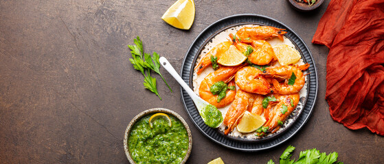 Fried shrimps with lemon and green in a plate, top view, web banner copy space for text