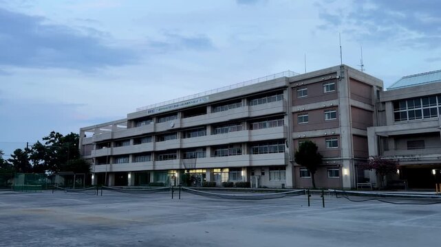 Large school building overlooking an empty sports field