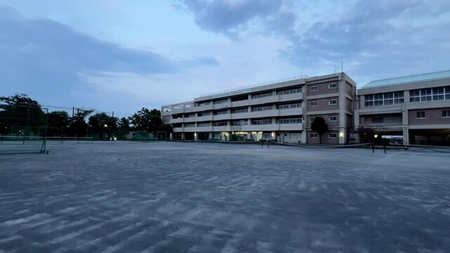 Empty schoolyard in front of a long campus building