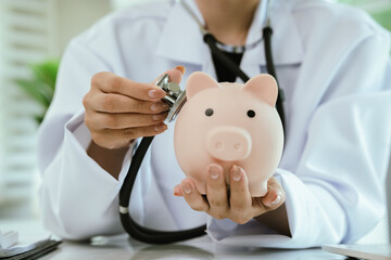 A piggy bank with a stethoscope symbolizes health insurance, medical savings, financial planning,...