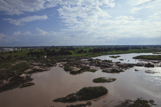 An aerial view of Tamburawa in Kano, where the river flows through rocky landscapes and fertile farmlands, sustaining communities and nature alike.
