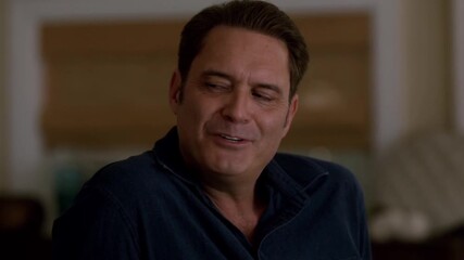 Acclaimed actor Andy Garcia beaming with joy, donning dark blue shirt, flashing warm smile while gazing off camera with serene, content demeanor