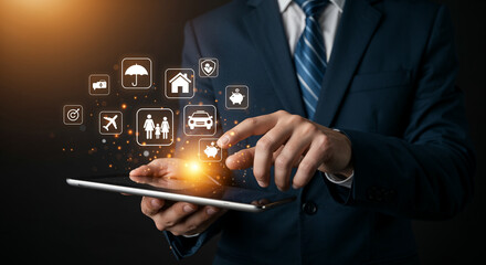Close-up of businessman holding tablet with floating insurance icons.