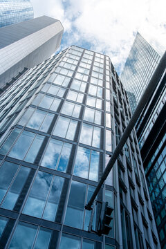 Tall financial skyscraper with mirrored glass facade, symbolizing corporate power, economic growth, modern business innovation and international investment