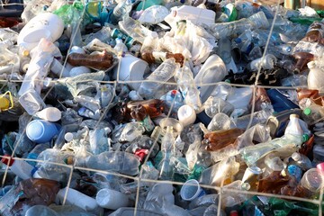 Pile of plastic bottles and waste at a landfill — symbol of the global issue of environmental...