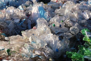 Mountains of compressed plastic bottles prepared for recycling — a symbol of the modern...