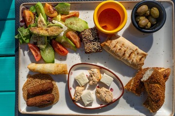Mediterranean breakfast platter on a blue table