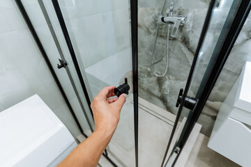 Discover a sleek and stylish shower space featuring modern black fixtures beautifully complemented...