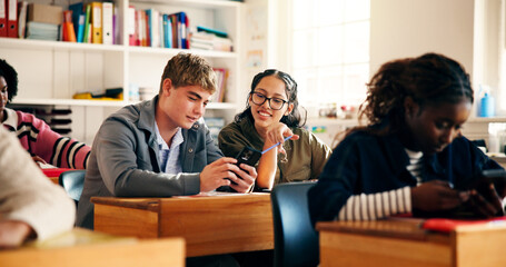 Learning, students or friends with phone in classroom for research, online course or smile. Teenager, boy and girl with mobile for education assignment, scholarship or chat for high school curriculum