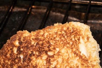 Close up of toasted burger bun being grilled