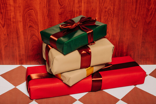 Stack of vintage handmade Christmas gift boxes with ribbons indoors