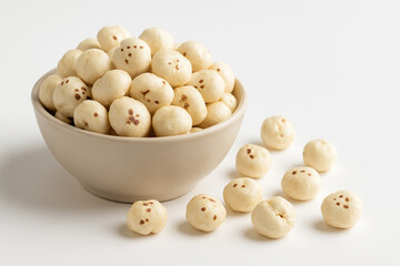 High quality photo realistic image of healthy puffed lotus seeds makhana in bowl isolated on clean white background for commercial use