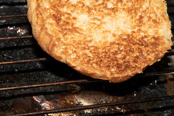 Close up of toasted burger bun being grilled