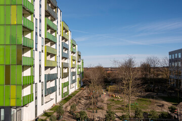 Green residential building facade in Copenhagen, symbolizing eco-friendly urban housing, sustainable design, modern architecture and community identity
