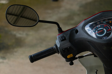 Close-up detail of the handlebar, mirror, and speedometer of a scooter in Vietnam. A common vehicle in Asia. © Nguyen Tuan