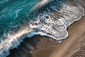 An impressive aerial view reveals waves crashing powerfully on a sandy beach