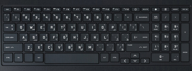 Close-up and full view of a modern Arabic-English computer keyboard