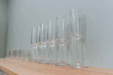 This piece showcases an elegant and meticulously curated arrangement of glassware placed delicately...