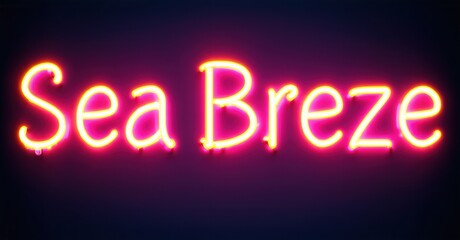 Bright pink neon sign displays words Sea Breeze against dark purple background. Simple lettering, vibrant illumination.