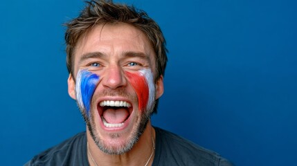 Man with a red, white, and blue face paint is smiling and laughing. Concept of joy and excitement, possibly related to a sports event or celebration