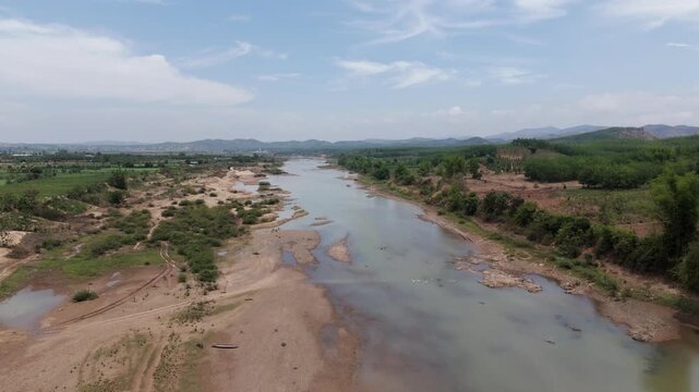 Drone footage above a river in Kon Tum province, camera is moving foward along a beautiful green countryside 2-2