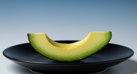 Avocado half on dark plate