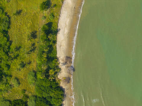 Aerial view of the vibrant beach with golden sand meeting the turquoise sea, fringed by the verdant greenery, Puerto Colombia, Atlantico, Colombia.