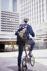 Smart businessman ride bicycle in downtown. Environmentalist commuting by cycling reduce carbon...