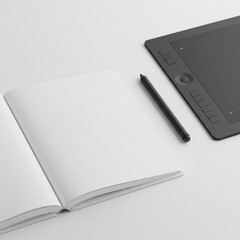 notebook and pen on the table - An open notebook with blank pages and a graphic tablet with a pen on a white surface, suitable for design, creativity, or office-related themes.