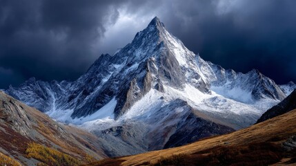 Dramatic Mountain Peak Surrounded by Dark Clouds and Snow at Elevation in a Scenic Landscape