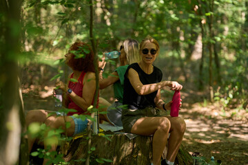 Women resting with picnic in forest
