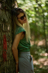 Woman resting with water bottle in forest