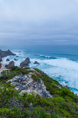 A secluded sandy cove framed by towering cliffs