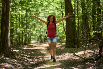 Happy woman hiking in forest
