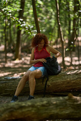 Woman taking snack break in forest
