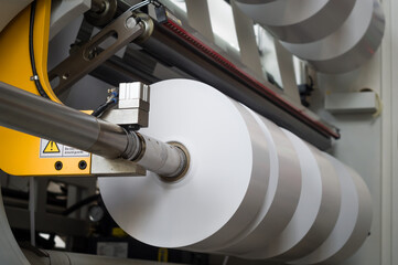 The process of winding paper self-adhesive tape into rollers of printing offer paper for printing...
