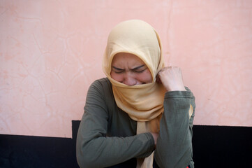 Young Asian Muslim Woman Covering Her Face With Veil Feeling Sad And Crying Desperately Outdoor