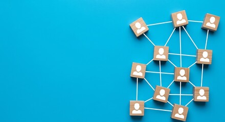 Small wooden blocks with person icons, interconnected by thin white strings, forming a network on a vibrant blue background.