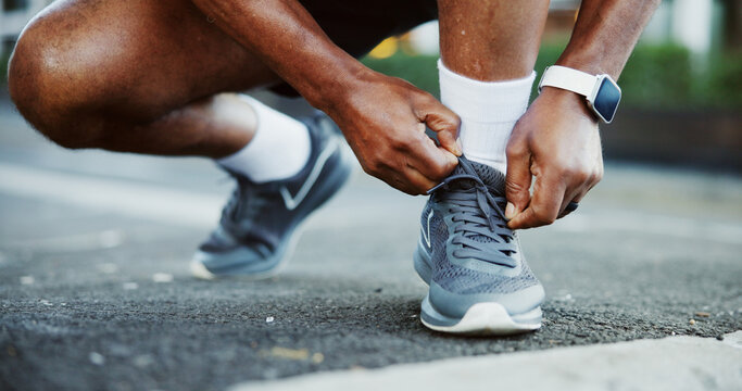 Hands, shoelaces and man in city, fitness and training for marathon, routine and exercise. Outdoor, person and athlete in street, sneakers and start day with practice, smart watch and workout