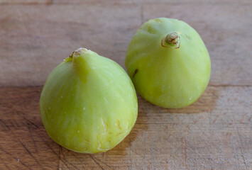 Green figs on a wooden cutting board