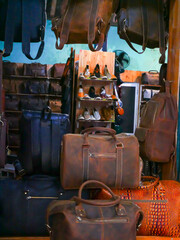 Upscale handmade leather backpack, shoes, boots, satchels line this Hoi An, Da Nang market stall....