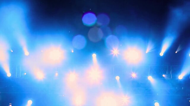 Bright stage lighting blue spotlights concert beams dramatic effects show performance entertainment dazzling lights vibrant energy powerful illumination
