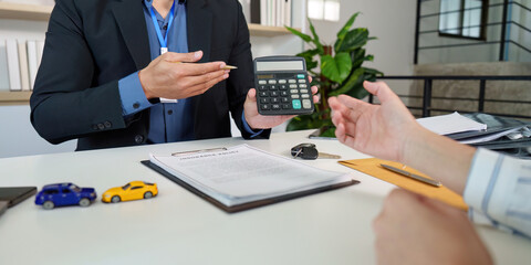 Insurance Consultation. Agent showing calculator to client.
