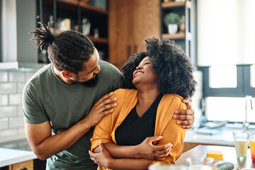Happy young afro american couple having fun preparing food  in kitchen