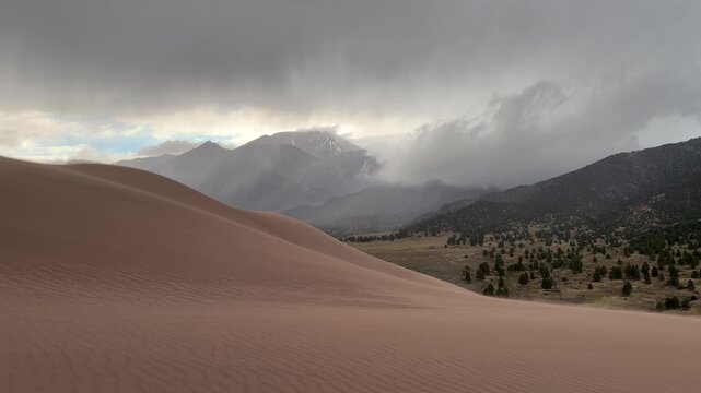Windy Great Sand Dunes National Park Spring summer stormy foggy cloudy raining mist Crestone Needle peak Colorado Sangre de Cristo range Rocky Mountains magical large amounts of sand dune hills pan