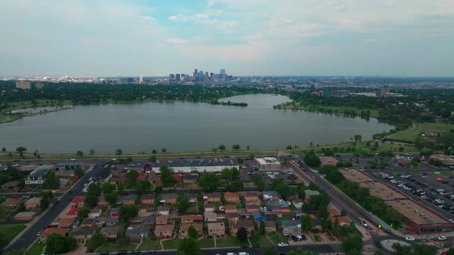 Summer at Sloans Lake Park downtown Denver spring Colorado aerial drone Edgewater Marketplace blue skies rain clouds cityscape skyscrapers neighborhood business Coflax Sherdian cars traffic pan left