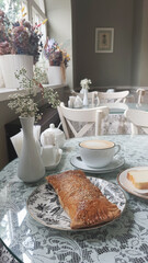 Elegant cafe setting with fresh pastry and coffee during a quiet morning