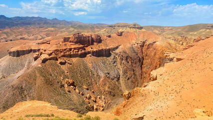 A desert landscape with a large orange Charyn canyon. An amazing natural phenomenon. A popular...